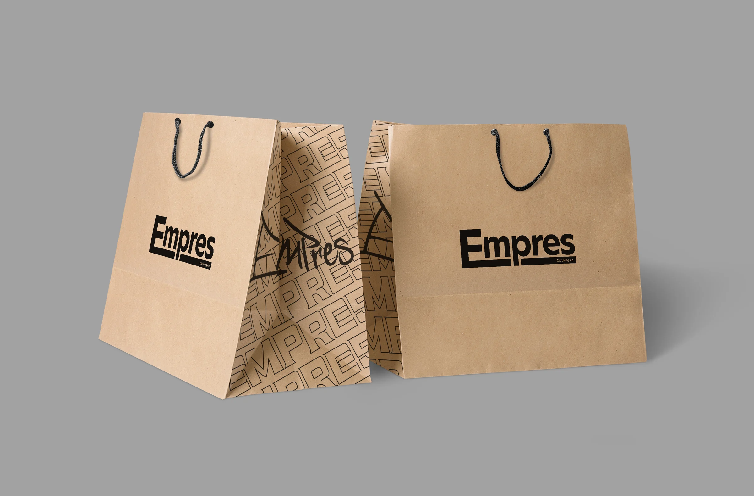 Two kraft paper Empres shopping bags with the black wordmark; the gussets are printed with a repeating EMPRES pattern and the hand-drawn tag